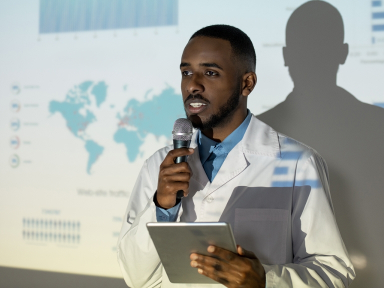 doctor in lab coat giving a speech