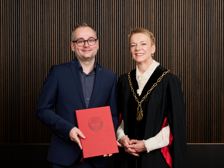 The awardee with the Rector of the University of Bern